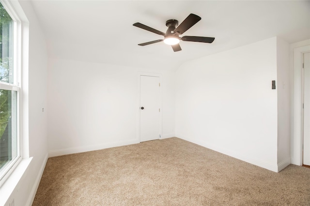 empty room featuring carpet floors, baseboards, and a ceiling fan