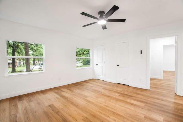 unfurnished bedroom with a ceiling fan, baseboards, and light wood-style floors