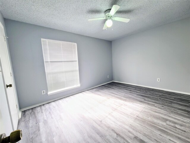 302 W Warrior Trl, Grand Prairie, TX 75052 - spare room with baseboards, a textured ceiling, ceiling fan, and wood finished floors