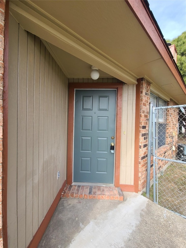 302 W Warrior Trl, Grand Prairie, TX 75052 - doorway to property with brick siding and central air condition unit