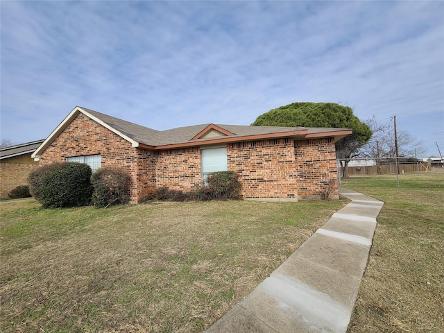 302 W Warrior Trl, Grand Prairie, TX 75052 - view of side of home with a lawn, roof with shingles, and brick siding