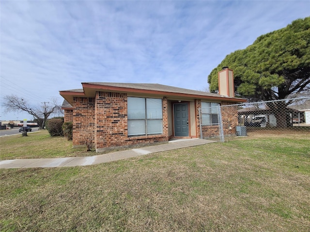 302 W Warrior Trl, Grand Prairie, TX 75052 - view of front of property with fence, brick siding, a front yard, central AC unit, and a chimney
