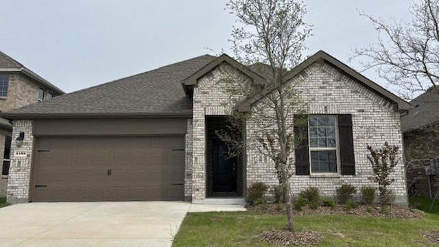 4189 Plateau Dr, Forney, TX 75126 - view of front of house with driveway, a garage, and brick siding