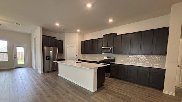 4189 Plateau Dr, Forney, TX 75126 - kitchen featuring appliances with stainless steel finishes, a sink, recessed lighting, a center island with sink, and decorative backsplash