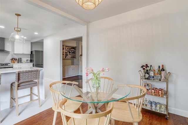 dining room with recessed lighting, baseboards, and wood finished floors