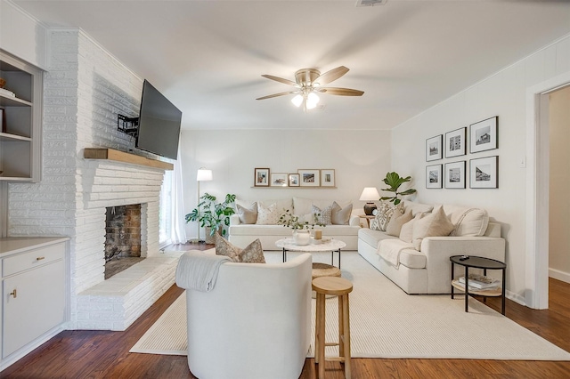 living room featuring visible vents, a ceiling fan, dark wood finished floors, and a fireplace