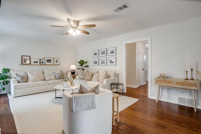 living room with visible vents, a ceiling fan, and dark wood-style floors