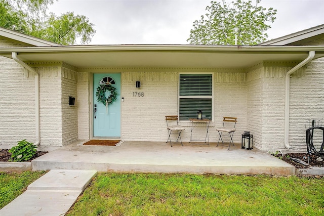 property entrance with brick siding