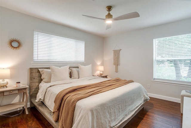 bedroom with baseboards, a ceiling fan, and dark wood-type flooring