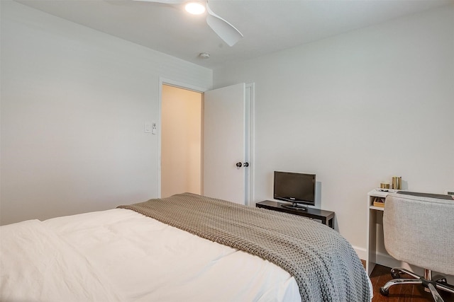bedroom featuring a ceiling fan and dark wood finished floors