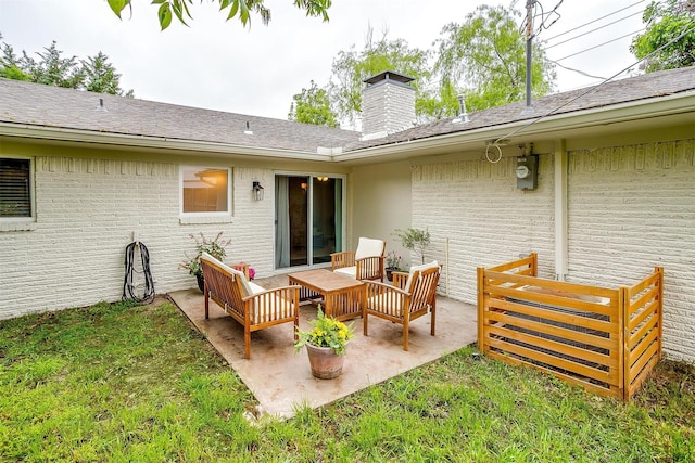 back of property with a lawn, a patio, an outdoor living space, and a chimney