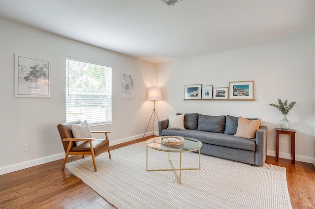 living room featuring baseboards and light wood finished floors