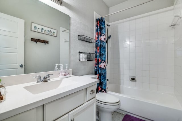 full bath featuring vanity, a textured wall, toilet, and shower / tub combo
