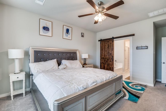 bedroom with visible vents, a barn door, and carpet