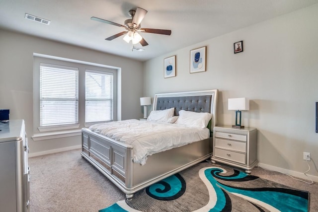 carpeted bedroom featuring baseboards, visible vents, and ceiling fan
