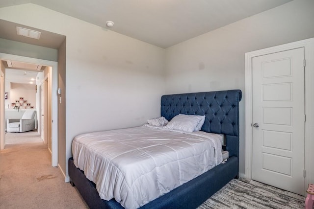 bedroom featuring carpet floors, attic access, and visible vents