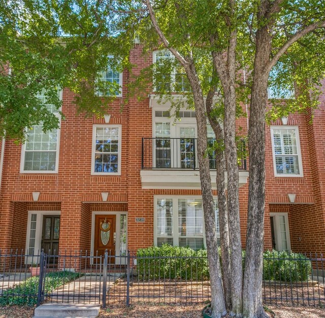 multi unit property with brick siding and fence