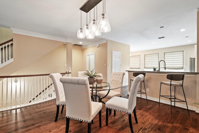 dining space with baseboards, ornamental molding, recessed lighting, and dark wood-type flooring