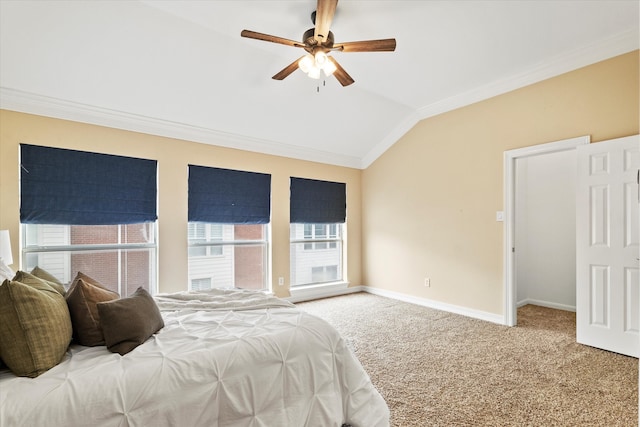 carpeted bedroom featuring baseboards, ornamental molding, vaulted ceiling, and multiple windows