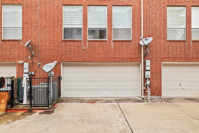 garage with fence and driveway