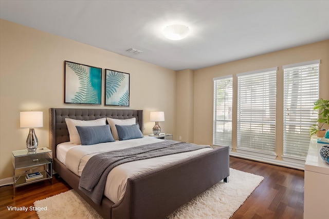 bedroom featuring visible vents and dark wood-type flooring