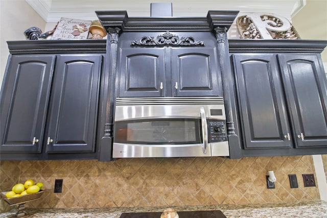 363 Leigh Ln, Stonewall, LA 71078 - kitchen view of stainless steel microwave, backsplash, crown molding, and light countertops