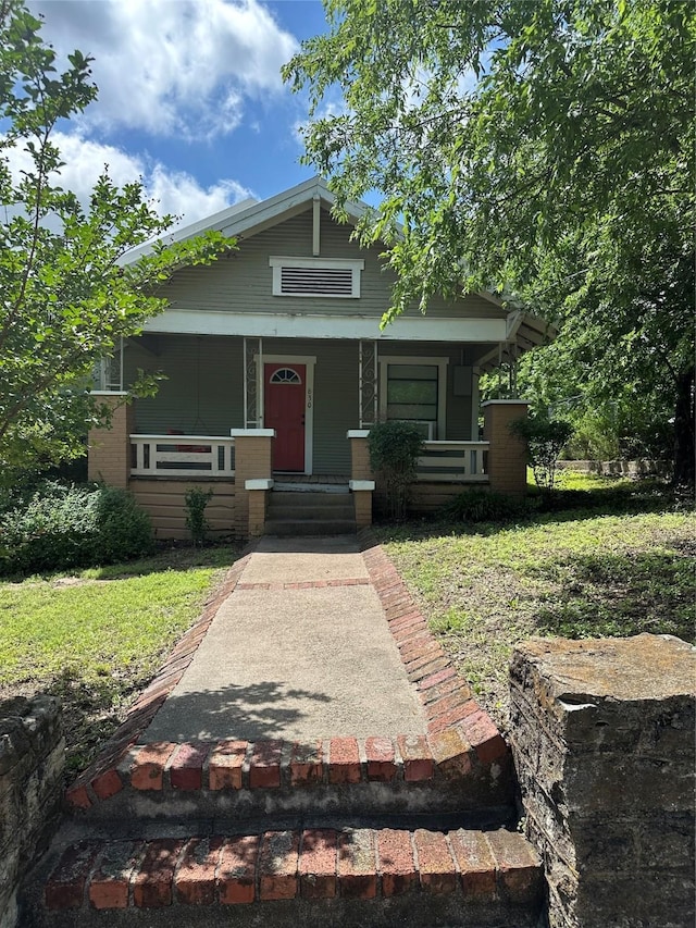 630 W College St, Stephenville, TX 76401 - view of front of home with a porch and a front yard