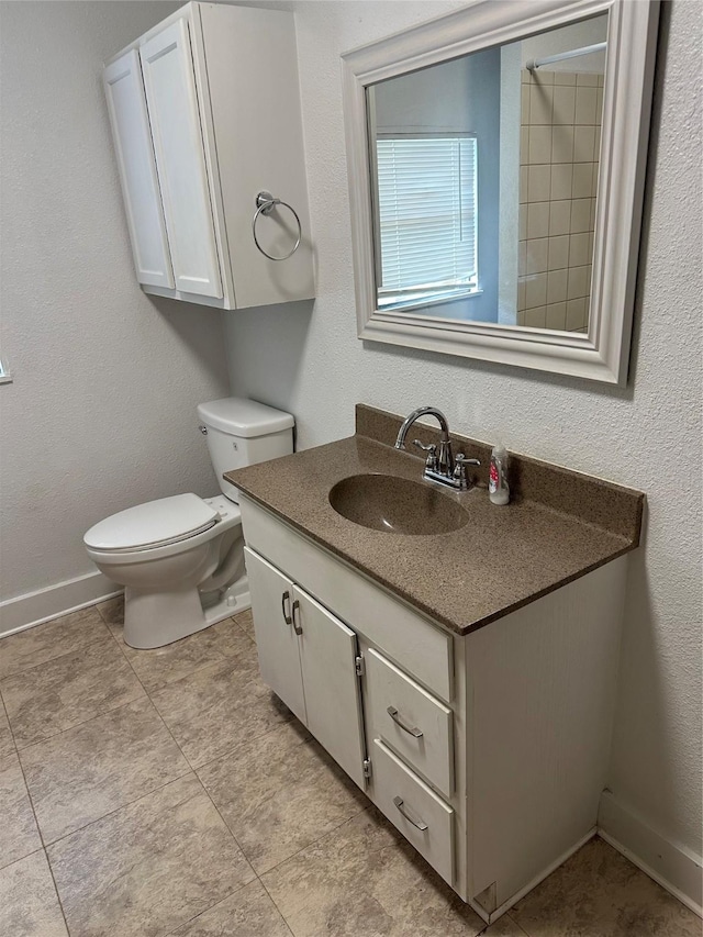 630 W College St, Stephenville, TX 76401 - bathroom with toilet, vanity, and baseboards