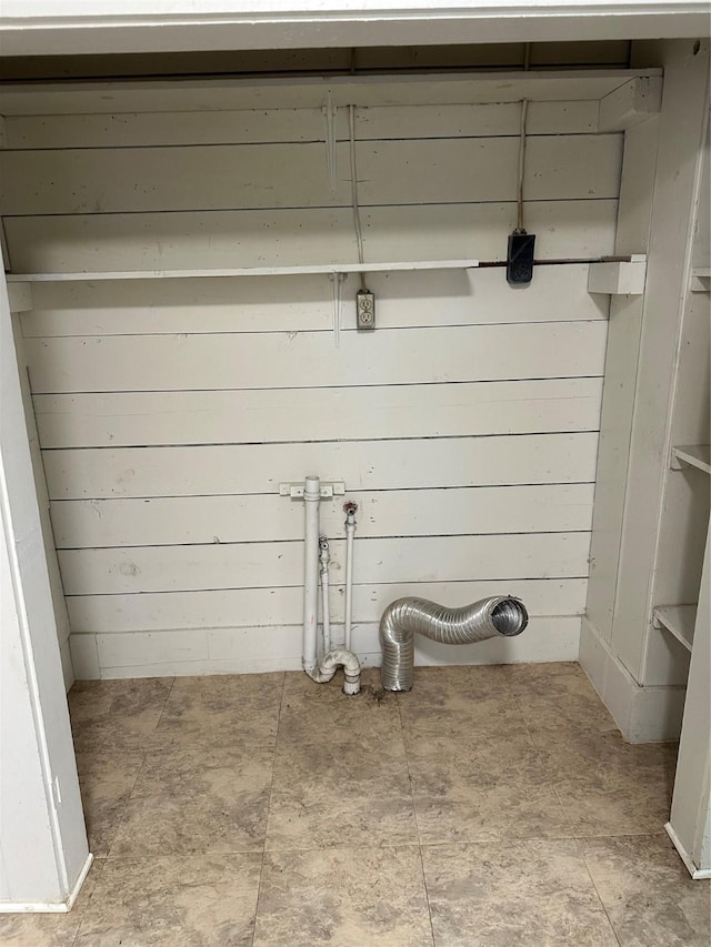 630 W College St, Stephenville, TX 76401 - laundry area featuring wood walls