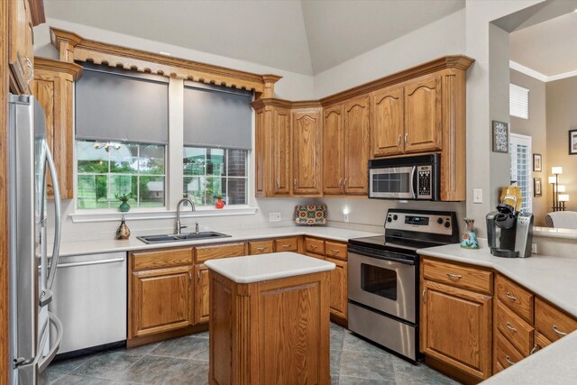 kitchen with a sink, appliances with stainless steel finishes, brown cabinets, and light countertops