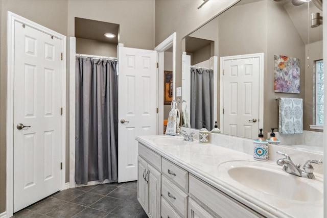 bathroom with a sink, tile patterned flooring, and double vanity