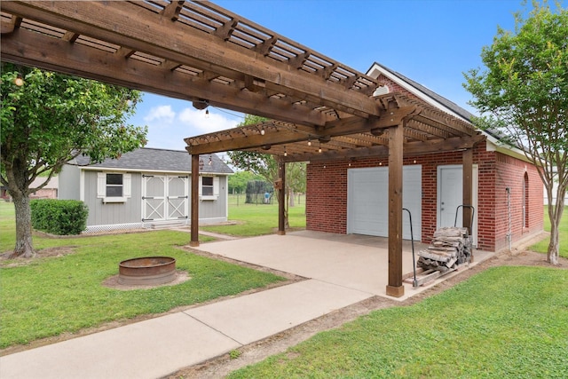view of patio / terrace featuring an outdoor structure, a garage, a fire pit, and a pergola
