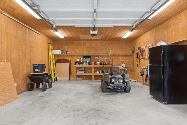 garage with freestanding refrigerator, wood walls, and a garage door opener