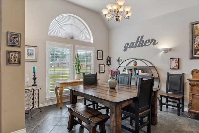 dining area with high vaulted ceiling, baseboards, stone finish floor, and a chandelier