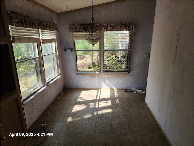 unfurnished dining area featuring stone finish floor and ornamental molding