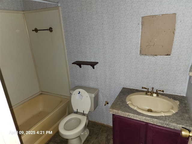 full bathroom featuring toilet, wallpapered walls, washtub / shower combination, and vanity
