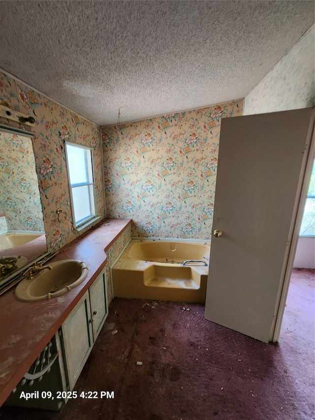 6108 County Road 809, Cleburne, TX 76031 - bathroom with wallpapered walls, a textured ceiling, a bath, and vanity