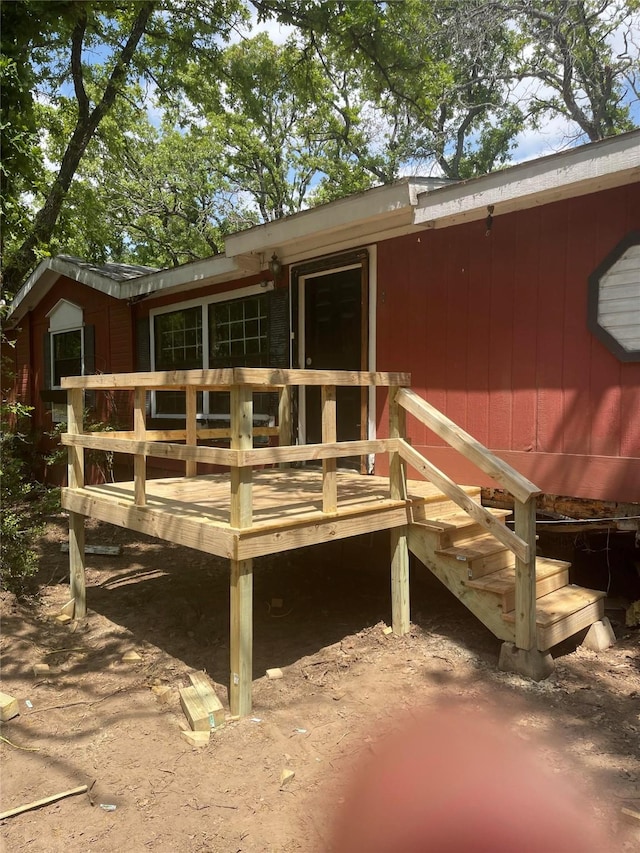 rear view of house featuring a wooden deck