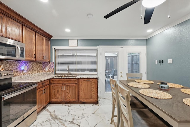 4006 Mayflower Dr, Garland, TX 75043 - kitchen with appliances with stainless steel finishes, a sink, crown molding, brown cabinets, and light marble finish floors