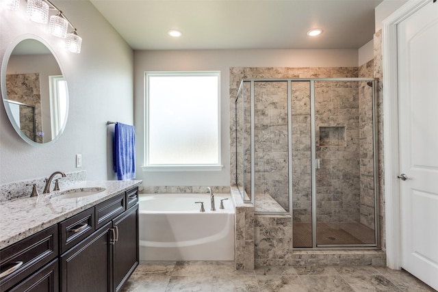 full bath with vanity, a garden tub, and a stall shower