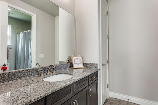 bathroom with vanity and baseboards