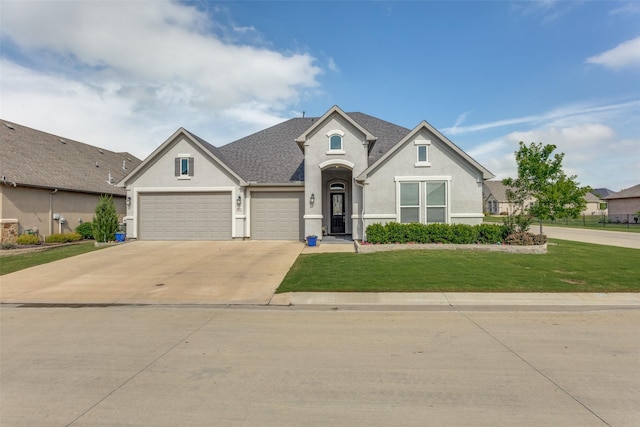 view of front facade featuring an attached garage, a front lawn, stucco siding, and driveway