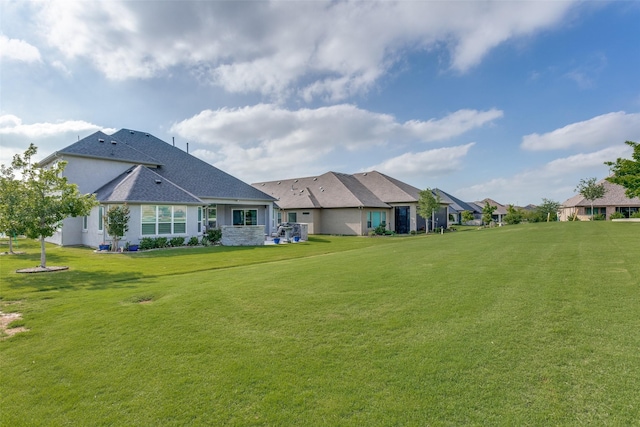 back of house featuring a residential view and a yard