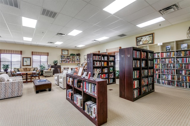 misc room with carpet, bookshelves, and visible vents