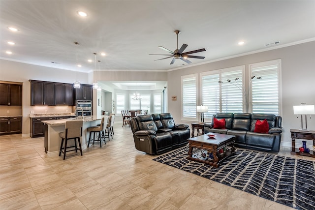 living room featuring visible vents, recessed lighting, crown molding, and ceiling fan with notable chandelier