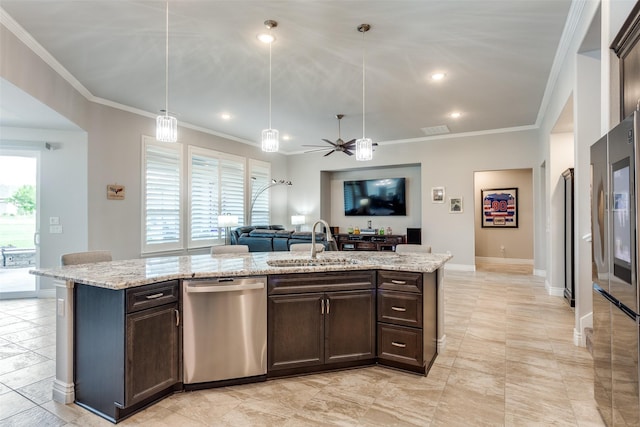 kitchen featuring dark brown cabinets, open floor plan, appliances with stainless steel finishes, and a sink