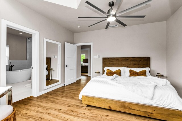 2856 Peninsula Dr, Grapevine, TX 76051 - bedroom with a skylight, ensuite bath, wood finished floors, and visible vents