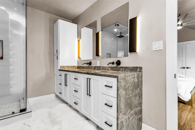 2856 Peninsula Dr, Grapevine, TX 76051 - full bathroom with a sink, baseboards, a stall shower, a ceiling fan, and ensuite bath