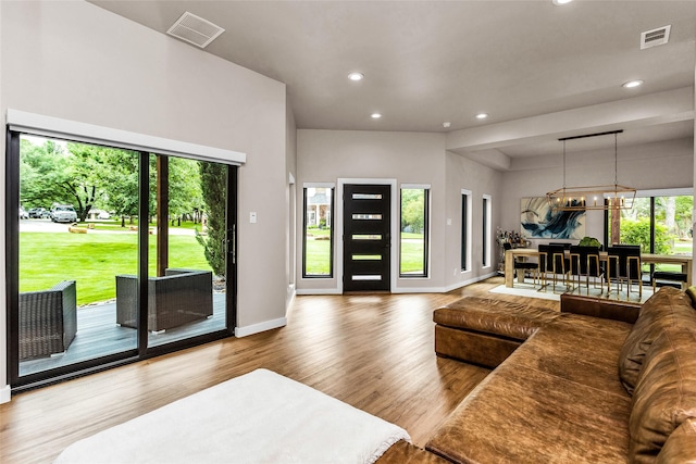 2856 Peninsula Dr, Grapevine, TX 76051 - living room featuring an inviting chandelier, recessed lighting, wood finished floors, and visible vents