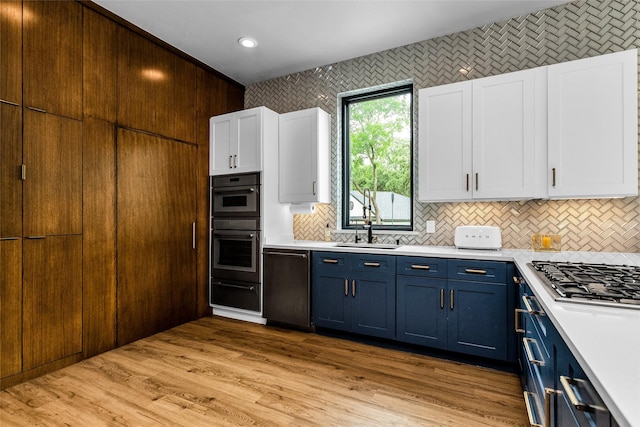 2856 Peninsula Dr, Grapevine, TX 76051 - kitchen featuring light countertops, blue cabinets, dishwashing machine, and stainless steel gas stovetop